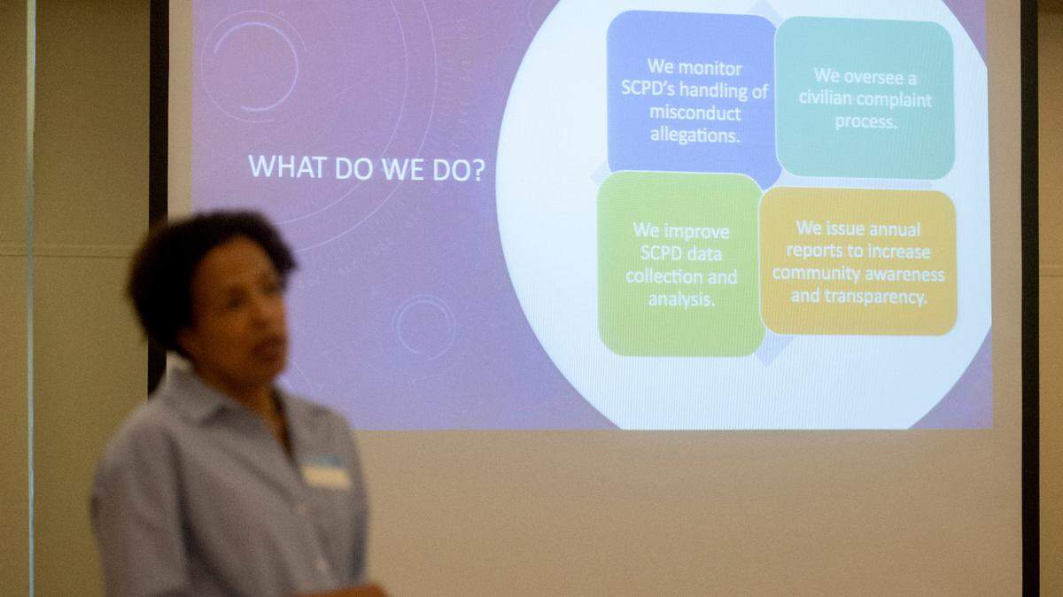 Cynthia Young talks about what the State College Community Oversight Board does during an open house on Oct. 3 at Schlow Library.