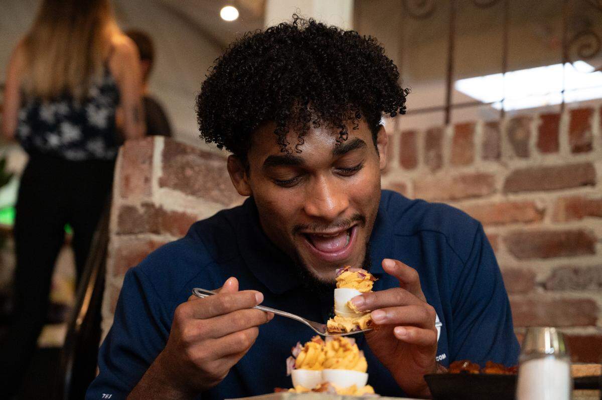 Carter Starocci eats deviled eggs for “Carter’s Drive and dine for Five” at Gigi’s Southern Table on Wednesday, Sept. 18, 2024.