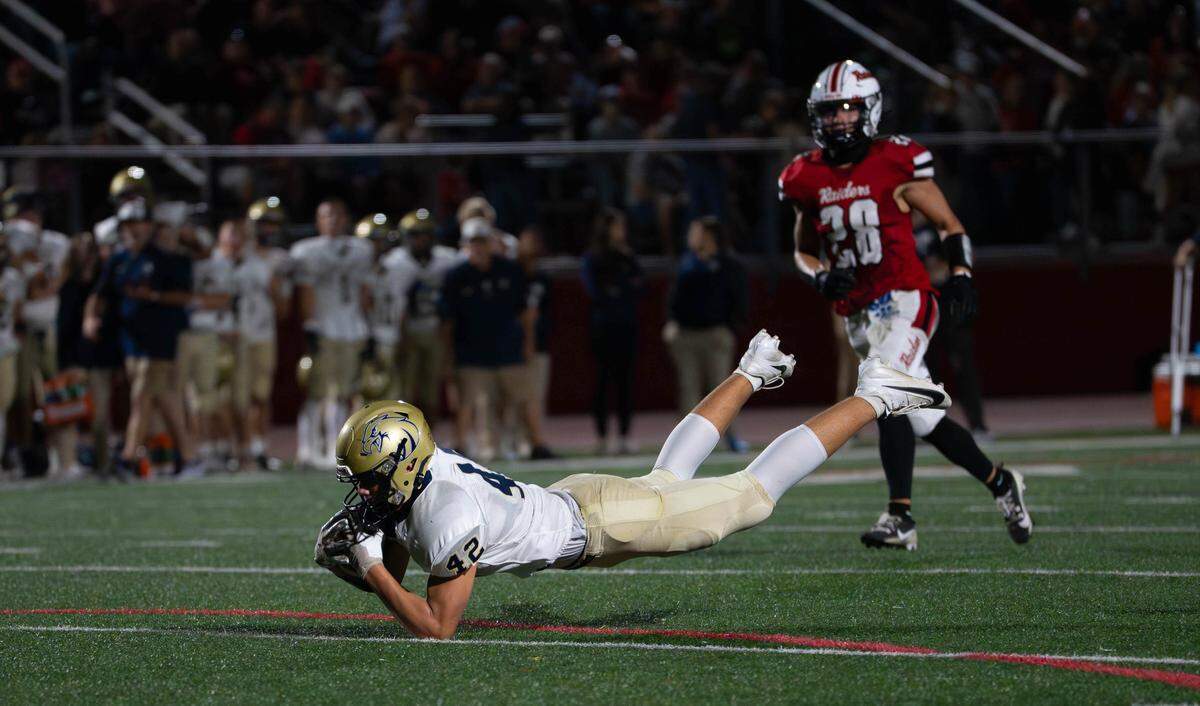 Bald Eagle Area junior tight end James Cowan (42) makes a diving catch during a Friday night football game between BEA and Bellefonte in Bellefonte, Pa., on Sept. 26, 2025. The Golden Eagles beat the Red Raiders 19-14.