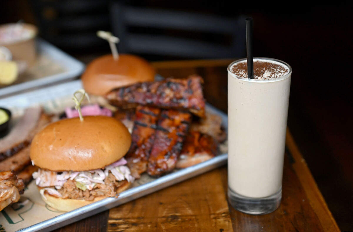 A Frozen Kentucky Coffee featuring whiskey and Rothrock coffee next to a plate of barbecue at Bill Pickles Tap Room on Wednesday, July 17, 2024.