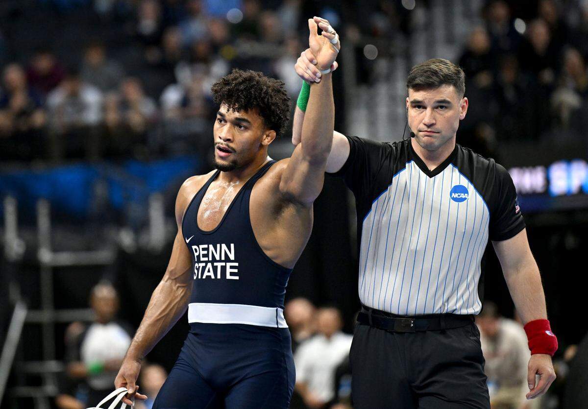Penn State’s Carter Starocci has his hand raised after beating Oklahoma State’s Dustin Plott in the 184-pound semifinal bout at the 2025 NCAA Wrestling Championships in Philadelphia on Friday, March 21, 2025.