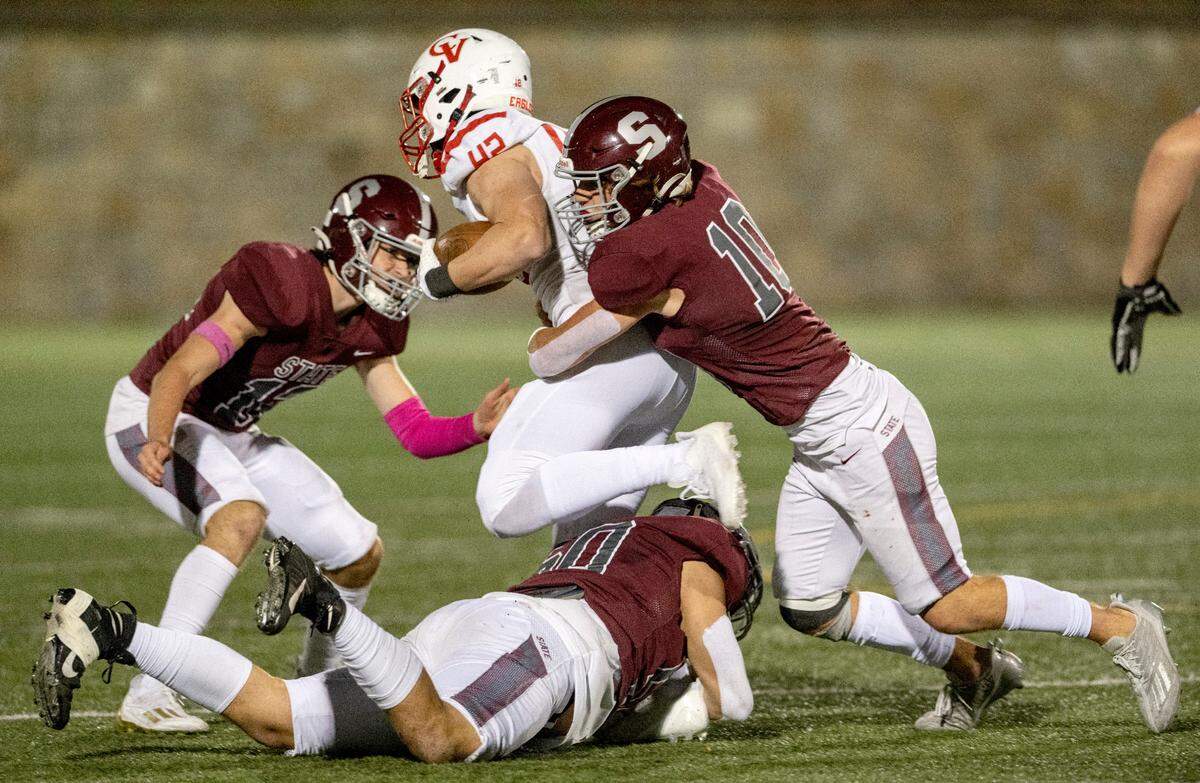 State College’s Sam Mayer and Michael Gaul stop Cumberland Valley’s Bryce Staretz during the game on Friday, Oct. 21, 2022 at Memorial Field.