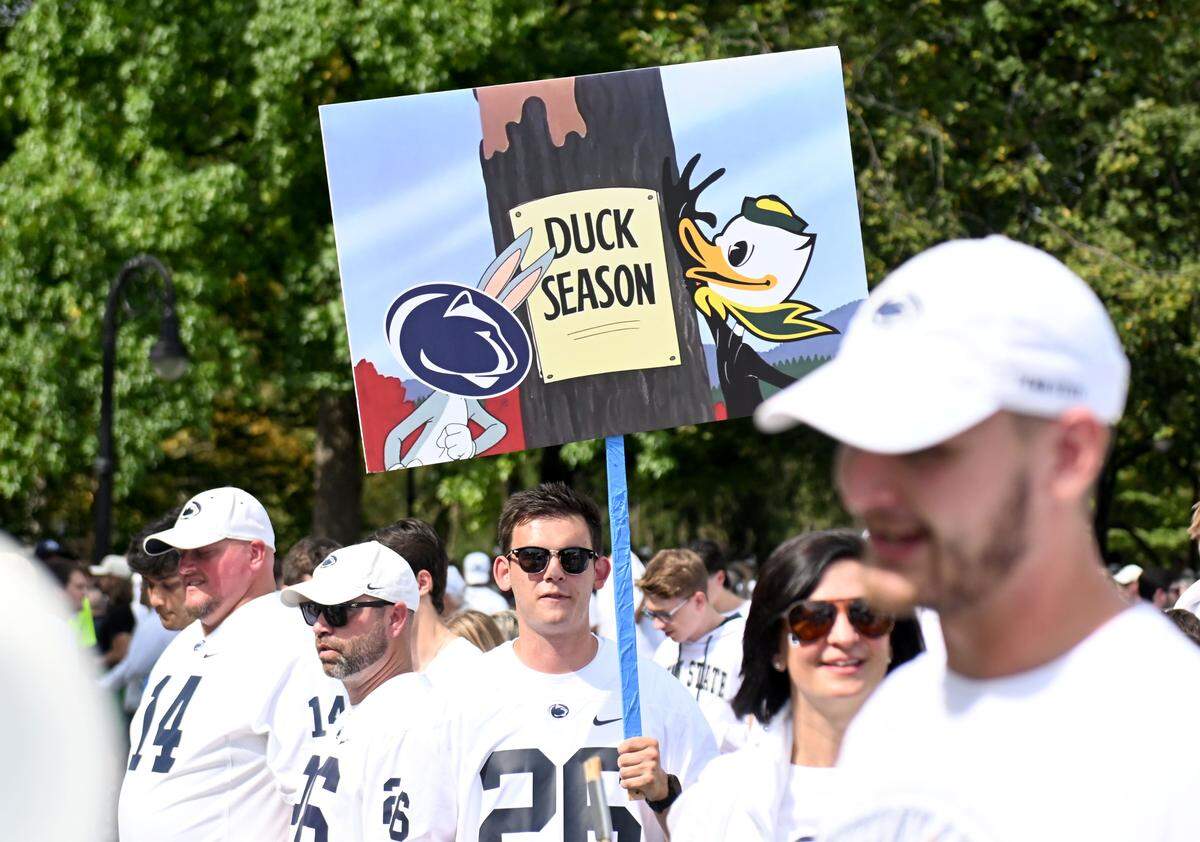 Fans hold up signs during ESPN’s College GameDay as it films at Penn State on Saturday, Sept. 27, 2025.  