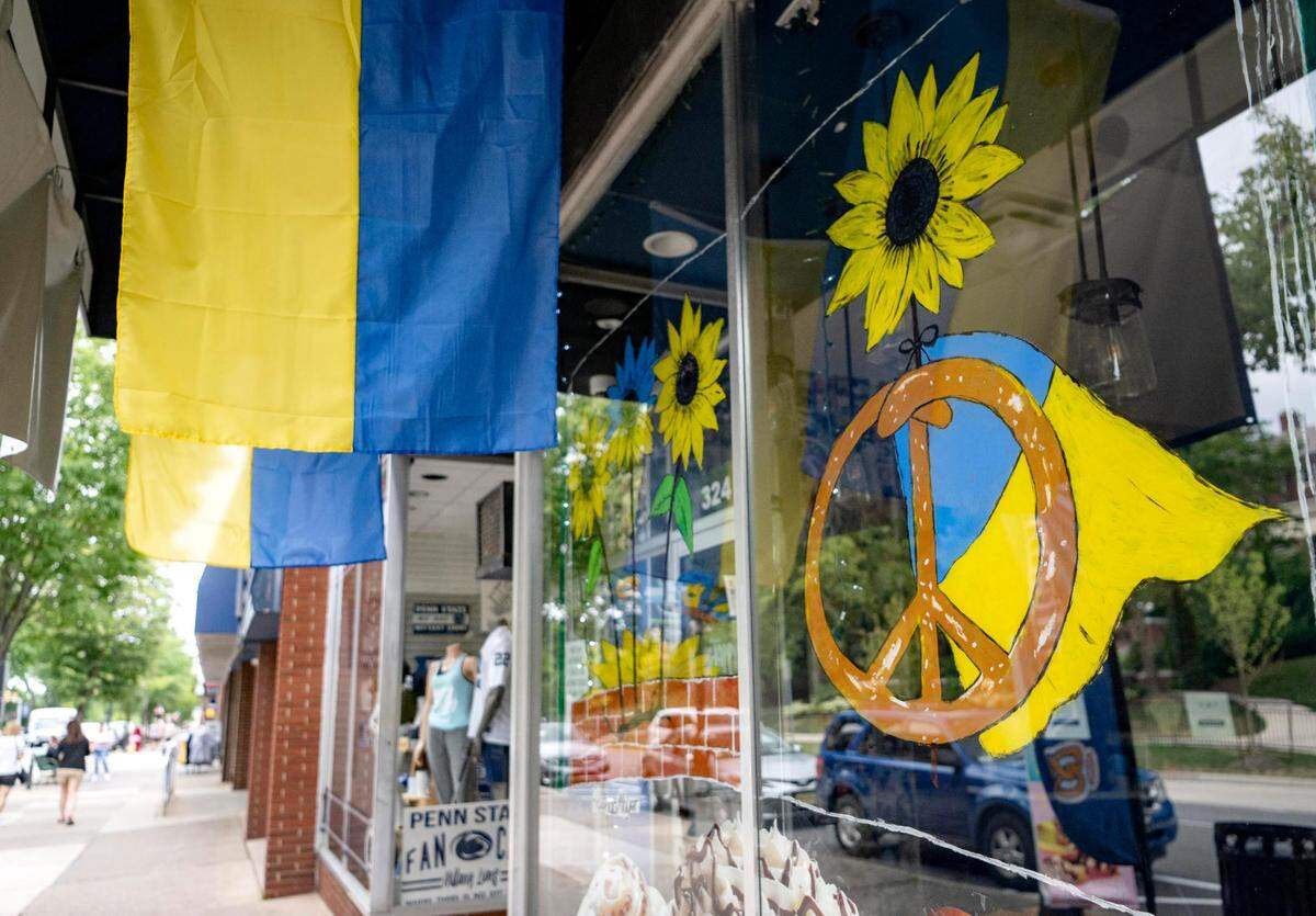 Ukrainian flags and sunflowers in the window of Auntie Anne’s, Cinnabon and Carvel on College Avenue as part of the Sunflower Solidarity with Ukraine initiative.
