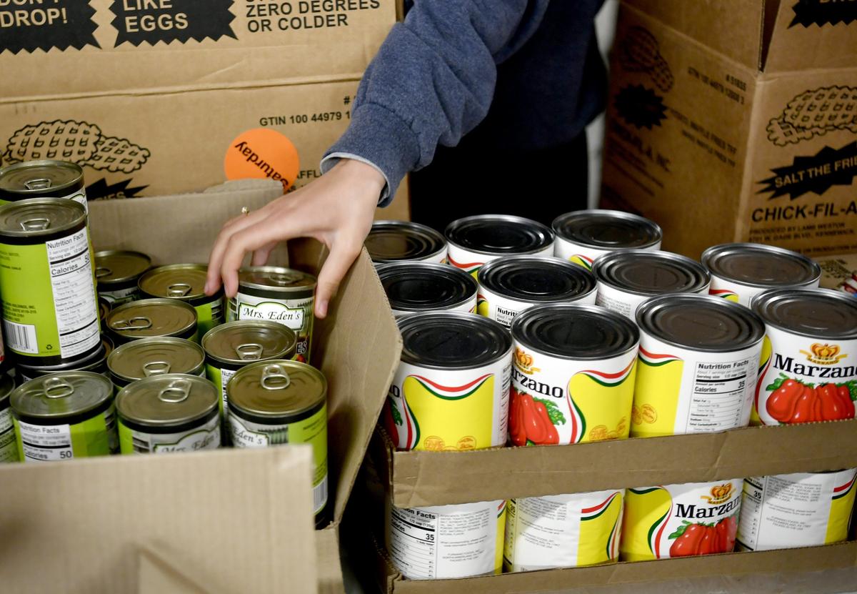 Volunteers pack boxes for Common Food on April 18.