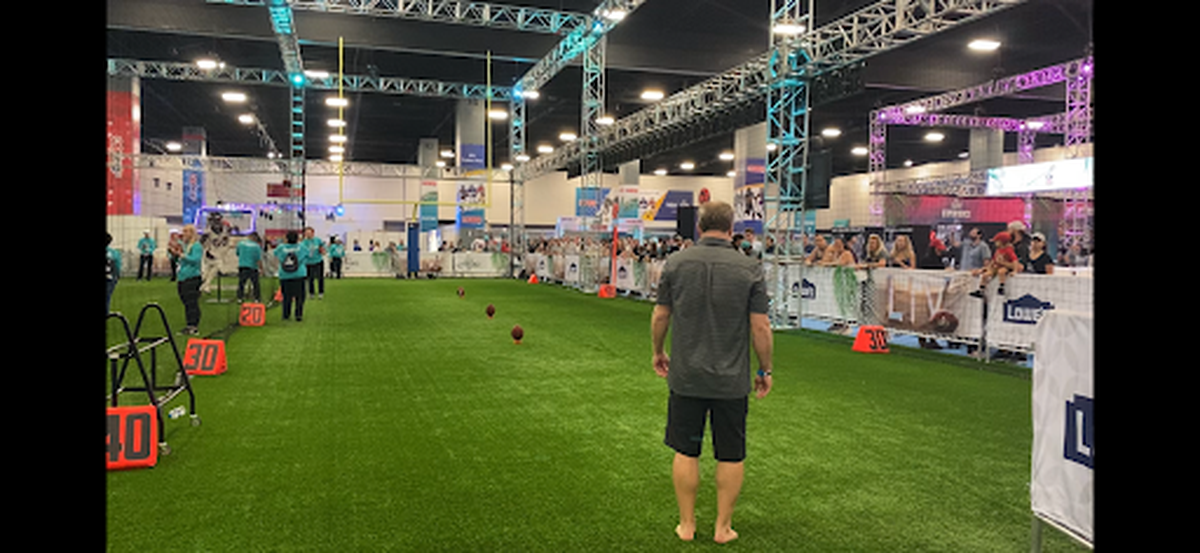 Fans, including this one who attempted a field goal in bare feet, got to test their skills at the NFL Fan Experience in the Miami Beach Convention Center during Super Bowl week in Miami.