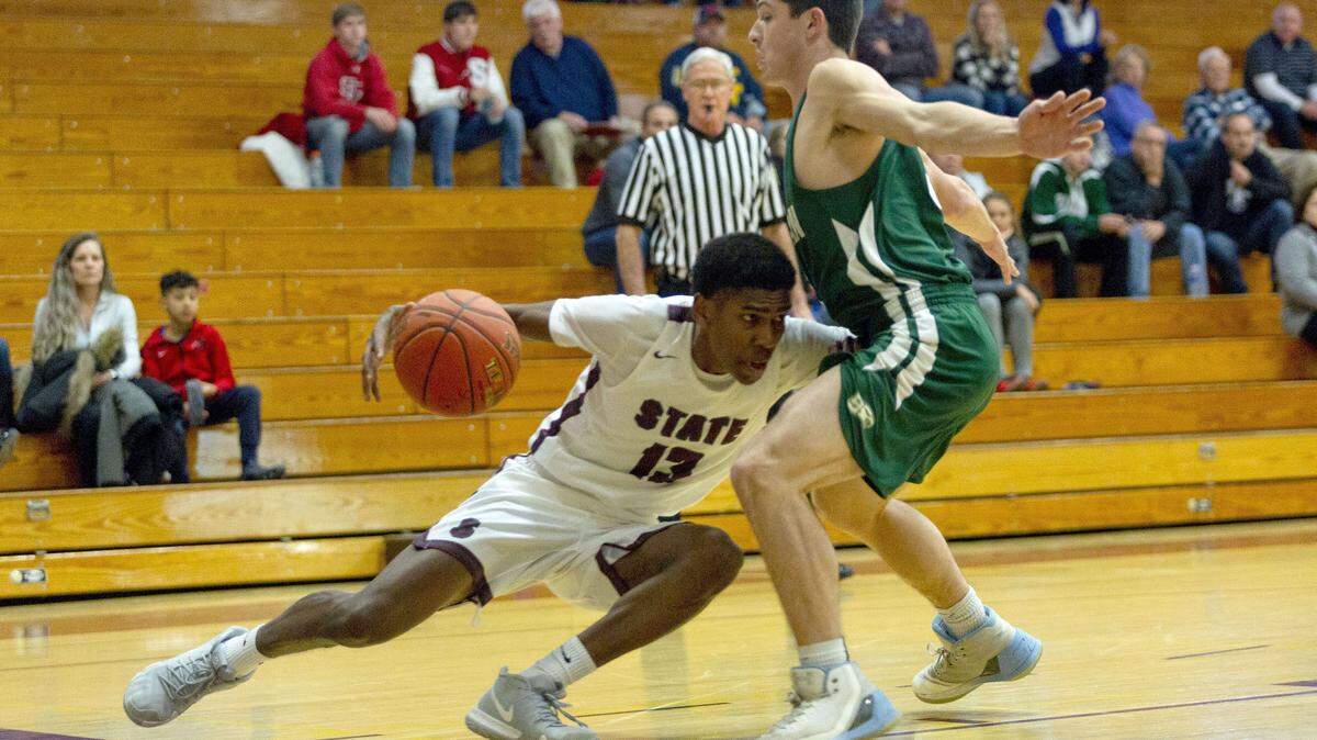 State College guard Cam Villarouel (13) slips while driving baseline during the consolation game of the Skip Coleman Tip Off Tournament against Bishop Shanahan at State College Area High School on Saturday, Dec. 8, 2018.