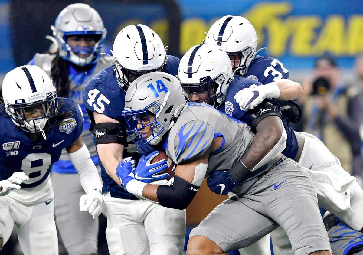 Penn State linebacker Charlie Katshir (45), linebacker Jesse Luketa (40) and safety Drew Hartlaub (37) stop Memphis wide receiver AntonioÊGibson during the Cotton Bowl at AT&T Stadium in Arlington, TX on Saturday, Dec. 28, 2019.