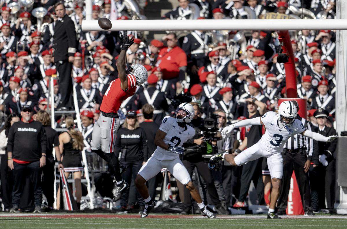 Ohio State wide receiver Jeremiah Smith makes a catch over Penn State defenders during the game on Saturday, Nov. 1, 2025. 