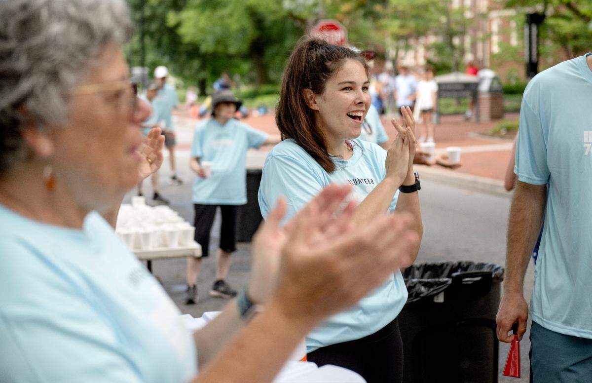 Sierra Schomburg cheers on runners as she volunteers during the Ironman 70.3 Pennsylvania Happy Valley on Sunday, June 30, 2024.