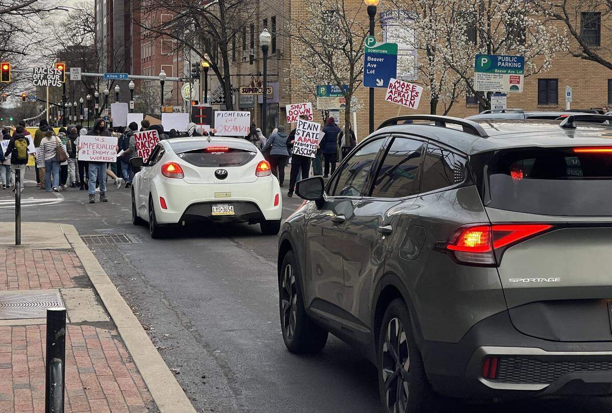 A group of about 50 Penn State student protesters marched in the streets in downtown State College on Tuesday evening after meeting at the Allen Street Gates.