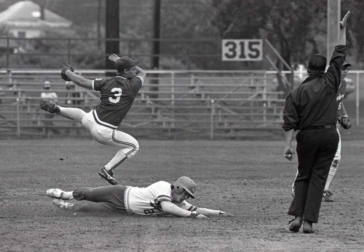 Bellefonte Area High School shortstop Larry Walker leaps to avoid a Bethel Park runner after recording a force out at second base during the PIAA Semi-Final game in 1987.