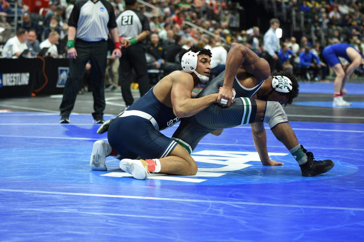 Penn State’s Carter Starocci attempts to keep Cal Poly’s Adam Kemp from escaping during their 174-pound second round match of the NCAA Championships on Thursday, March 17, 2022 at Little Caesars Arena in Detroit. Starocci got by Kemp, 10-4.