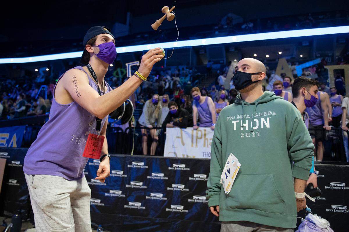 Isaac Goodman watches a member of his fraternity play kendama on Saturday during Day 2 of Thon.