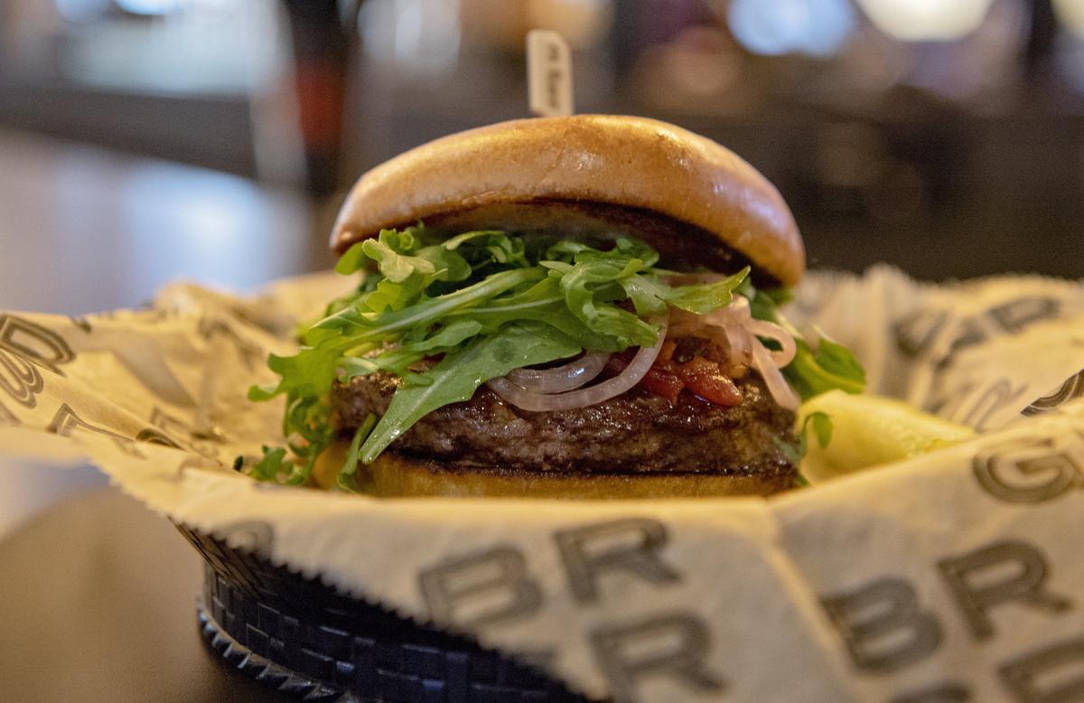 The BRGR burger includes dry aged prime beef, pickled red onions, arugula, creamy bleu cheese and roasted tomatoes at the newly opened BRGR on College Avenue in State College.