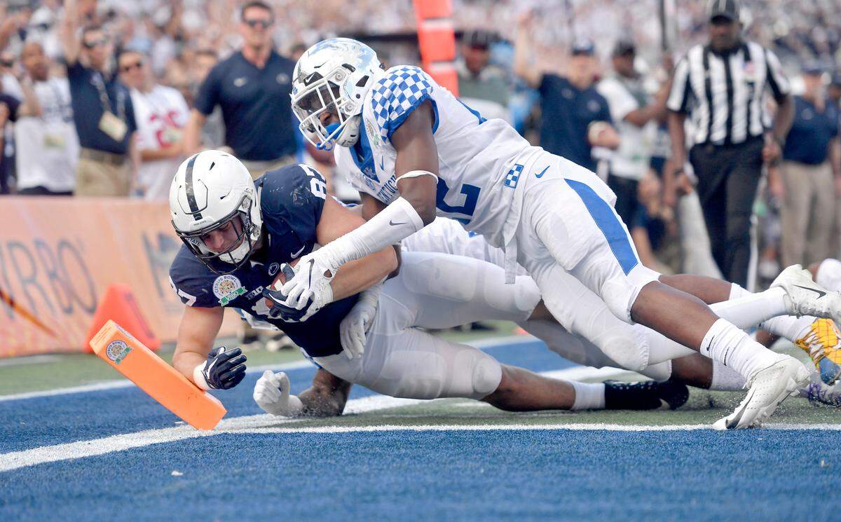 Kentucky defenders can’t stop Penn State tight end Pat Freiermuth as he dives into the end zone for a touchdown during the Citrus Bowl on Tuesday, Jan. 1, 2019 at Camping World Stadium.