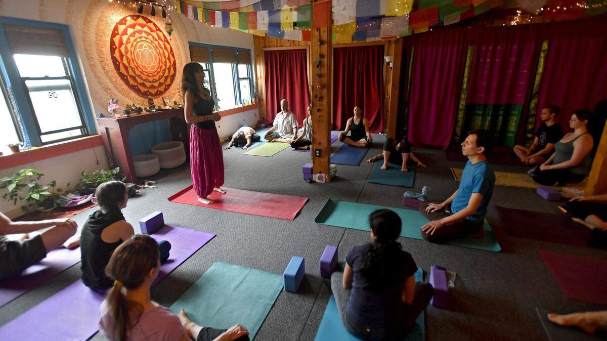 Erica Kaufman welcomes a class at Lila Yoga in May 2017. The State College studio incorporates local music into yoga sessions.