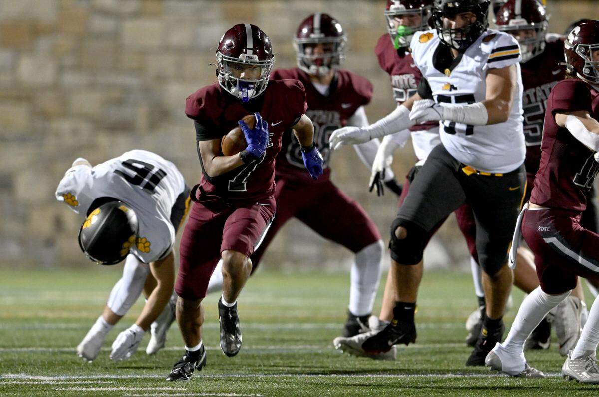 State College’s D’Antae Sheffey runs down the field from North Allegheny defenders during the PIAA class 6A quarterfinals game on Friday, Nov. 25, 2022 at Memorial Field.