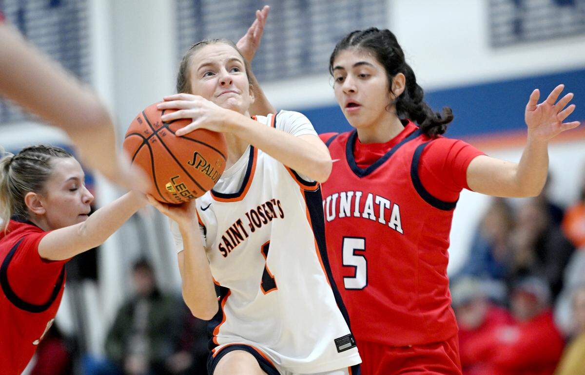 Saint Joseph’s Catholic Academy’s Alexia Luckovich goes in for a basket around Juniata defenders during the game on Thursday, Jan. 23, 2025. Saint Joseph’s Catholic Academy won, 72-34.