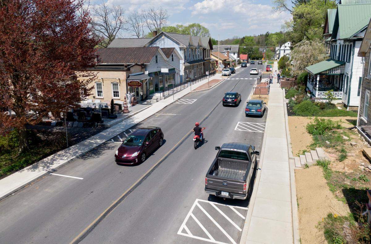 Cars travel along Pike Street in Lemont on Friday, April 21, 2023.