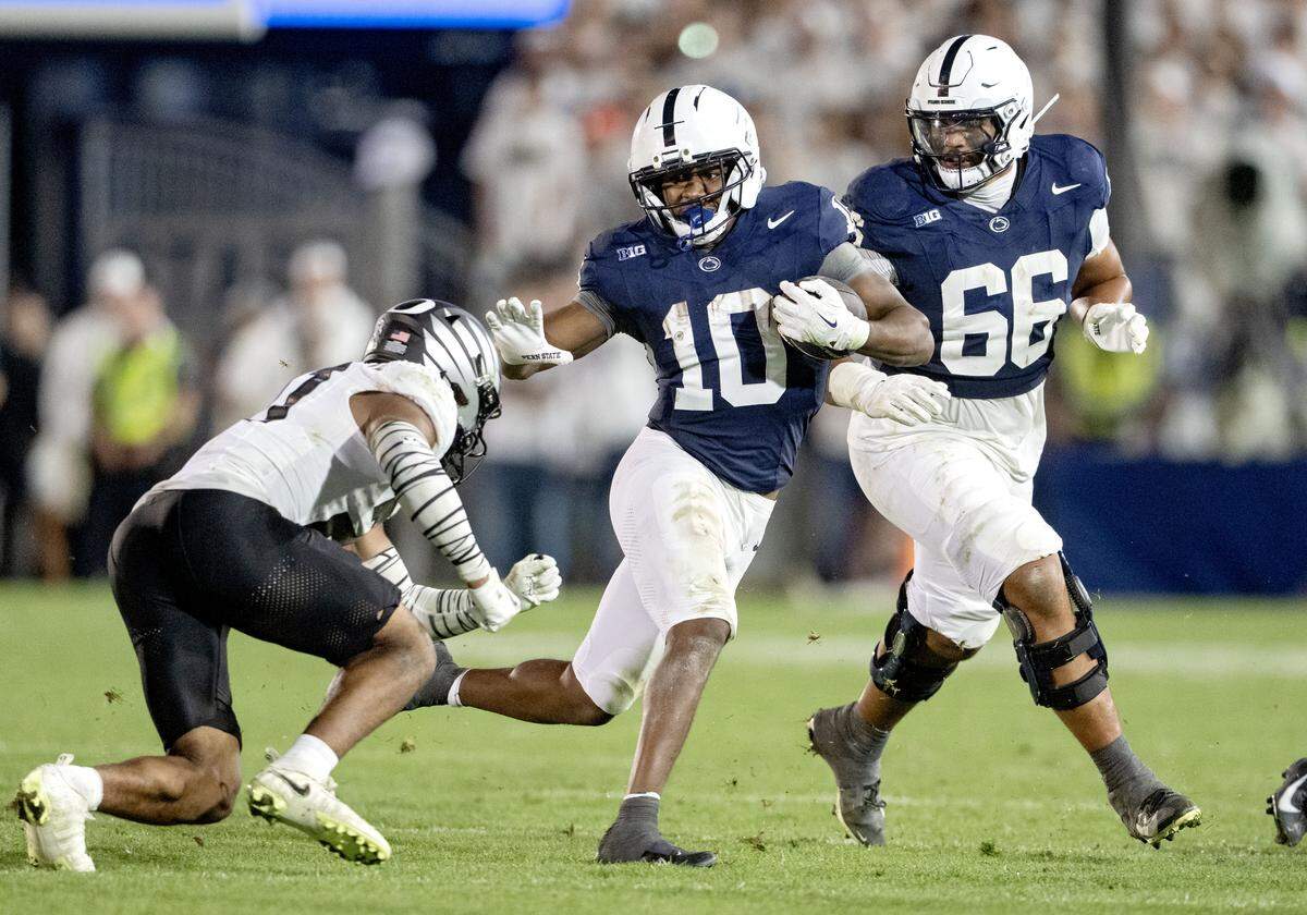 Penn State running back Nick Singleton dodges an Oregon defender during the game on Saturday, Sept. 27, 2025.