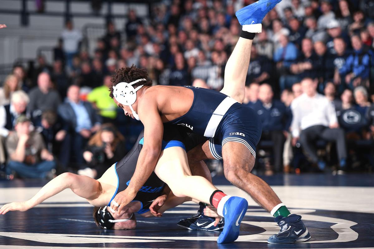 Penn State’s Mark Hall (right) drives Buffalo’s Jake Lanning to the mat Sunday at Rec Hall. Hall won by a pin. Penn State defeated Buffalo, 47-3.