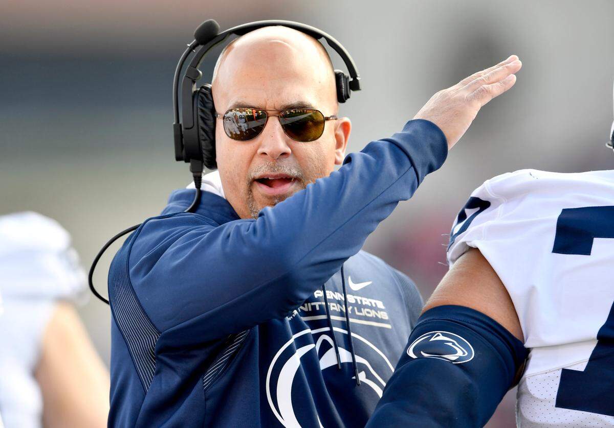 Penn State football coach James Franklin pats a players on the head as he comes off the field during the game against Maryland on Saturday, Nov. 6, 2021.