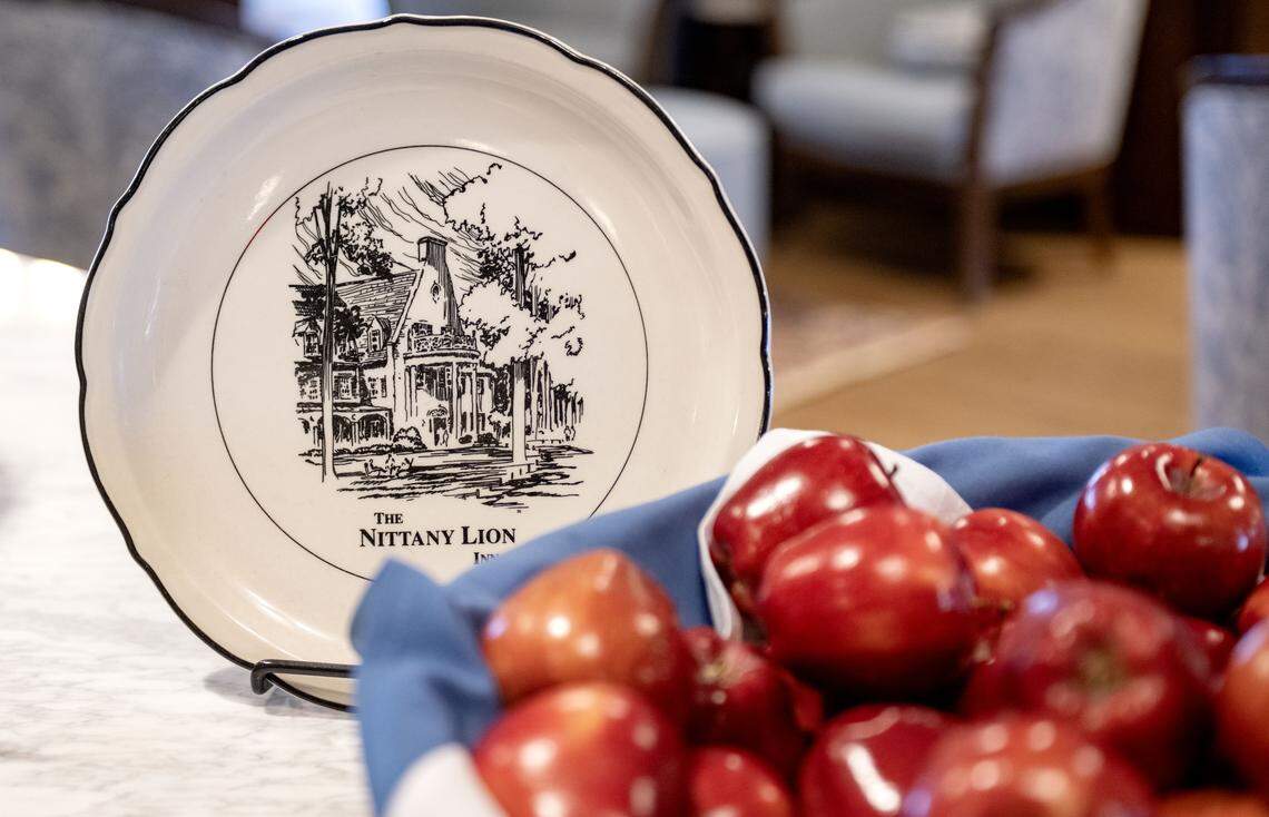 A plate featuring the Nittany Lion Inn next to a basket of apples in the lobby on Thursday, Jan. 14, 2026.  