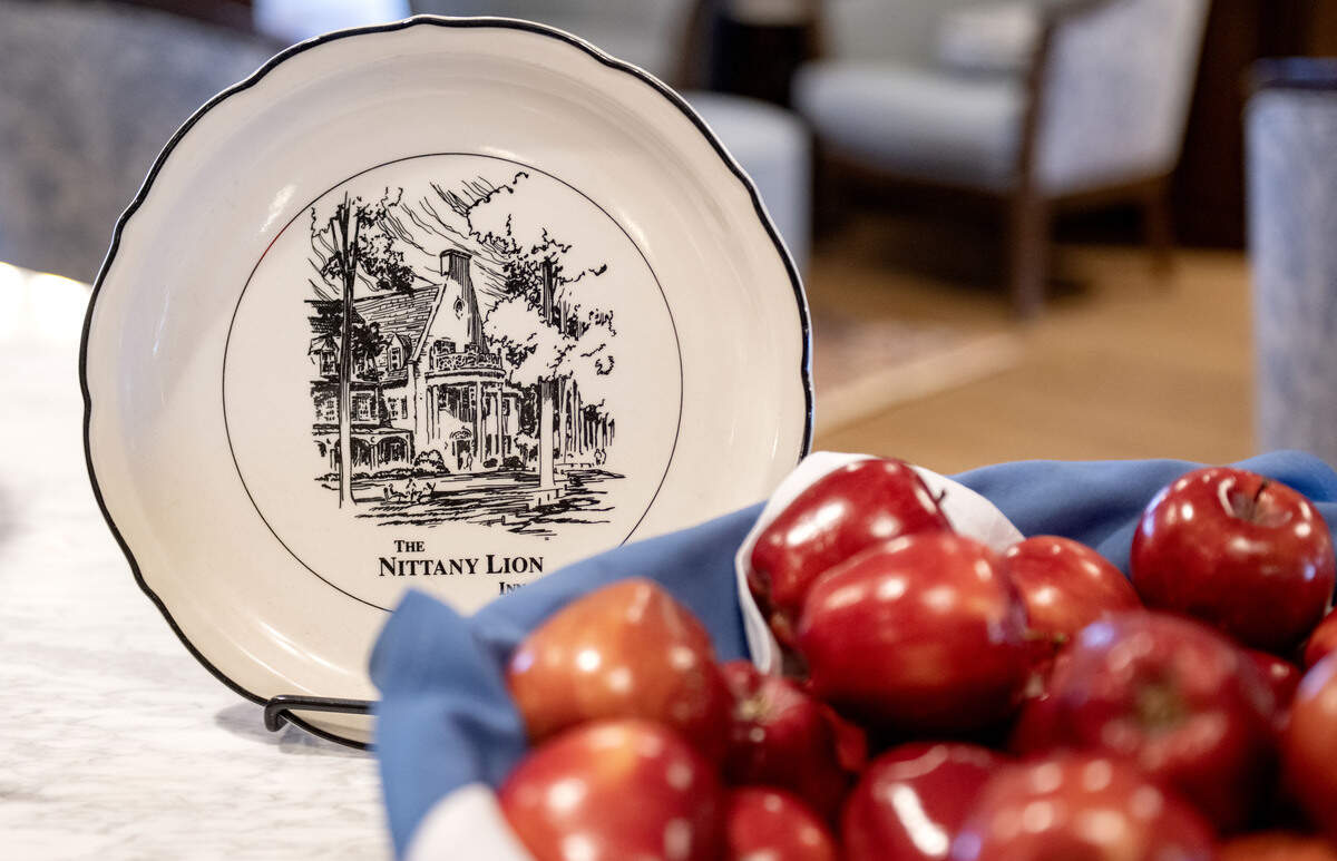 A plate featuring the Nittany Lion Inn next to a basket of apples in the lobby on Thursday, Jan. 14, 2026.