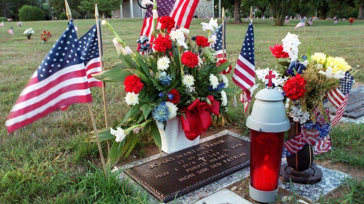 The gravesite of September 11, 2001 terrorist attack victim Jonas M. Panik is decorated on the first anniversary Sept. 11, 2002 at the Centre County Memorial Park.