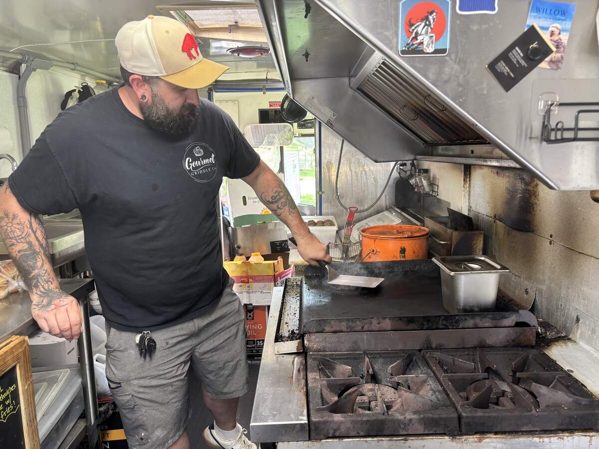 Brandtly Ward makes a BCB Burger, which is a staple menu item at Gourmet Griddle, inside his food truck on Monday, June 15, 2026.
