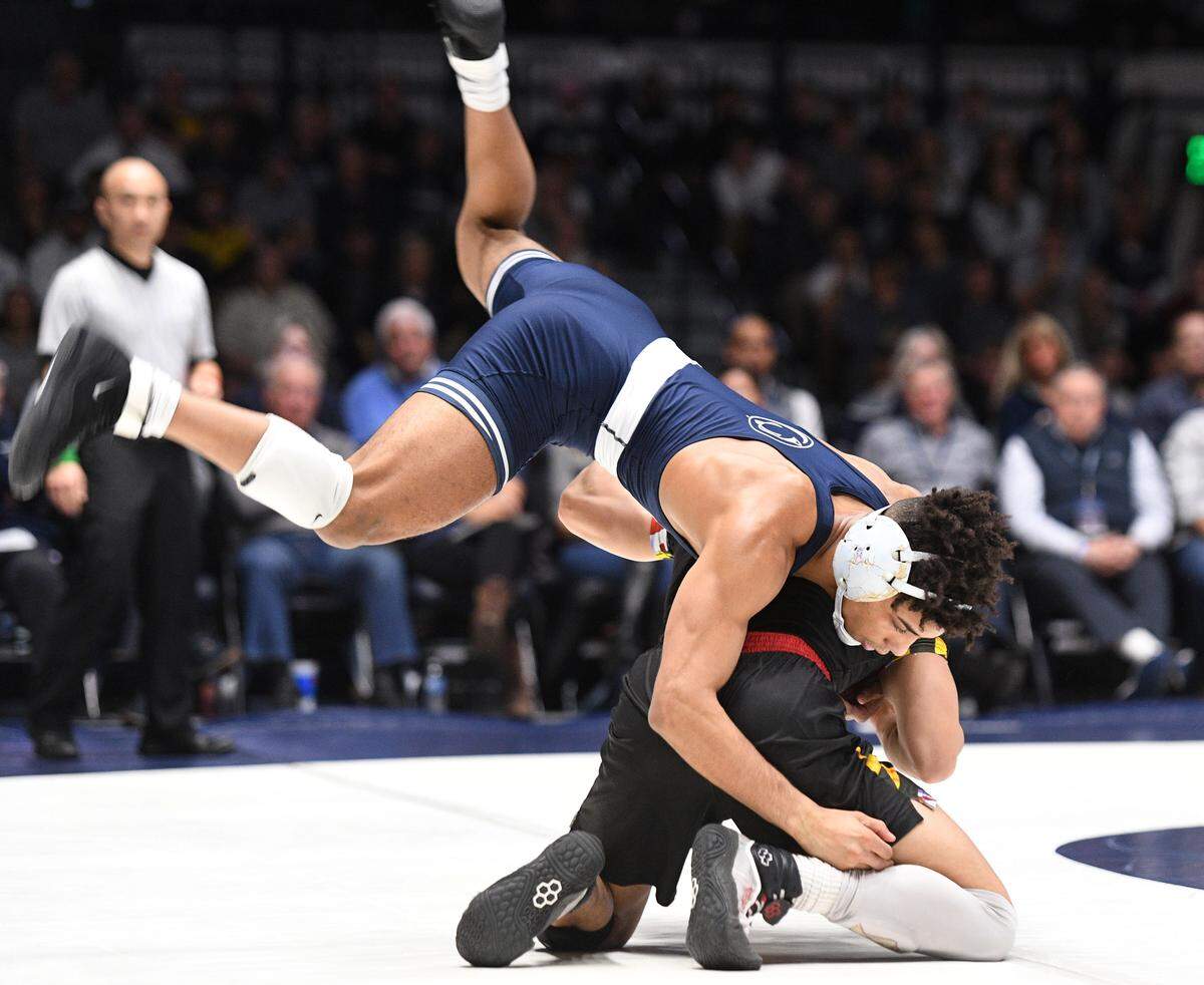 Penn State’s Roman Bravo-Young (top) flips his position for a take-down over Maryland’s King Sandoval during Sunday’s meet at Rec. Hall. Bravo-Young defeated Sandoval, 24-9. Penn State defeated Maryland, 40-3. (For the CDT/Steve Manuel)
