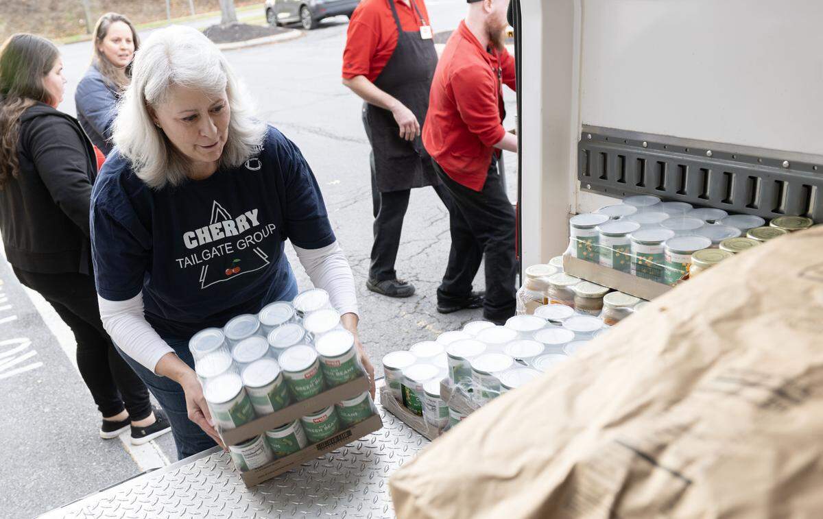 Tess Clapper helps load the makings for Thanksgiving dinners into the State College Food Bank van at the Weis on Westerly Parkway on Monday, Nov. 24, 2025.