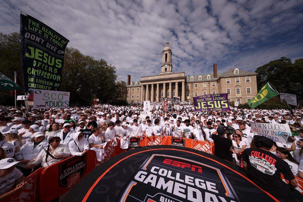 Penn State fans, many of them students, gather Saturday morning for ESPN’s College GameDay on the lawn of Old Main on the Penn State campus.