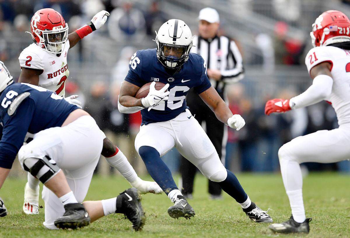 Penn State running back Caziah Holmes cuts down the field from Rutgers defenders during the game on Saturday, Nov. 20, 2021.