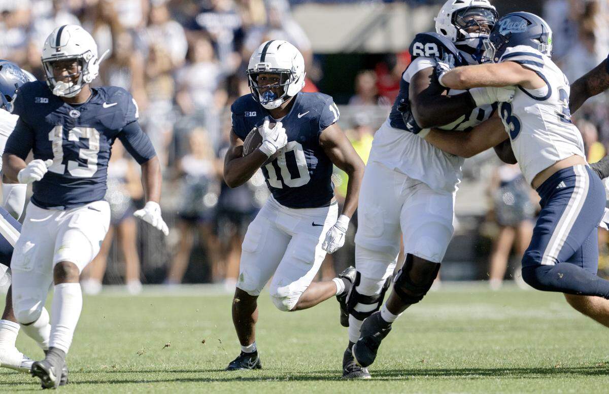 Penn State running back Nick Singleton cuts down the field with the ball during the game against Nevada on Saturday, Aug. 30, 2025 at Beaver Stadium.  