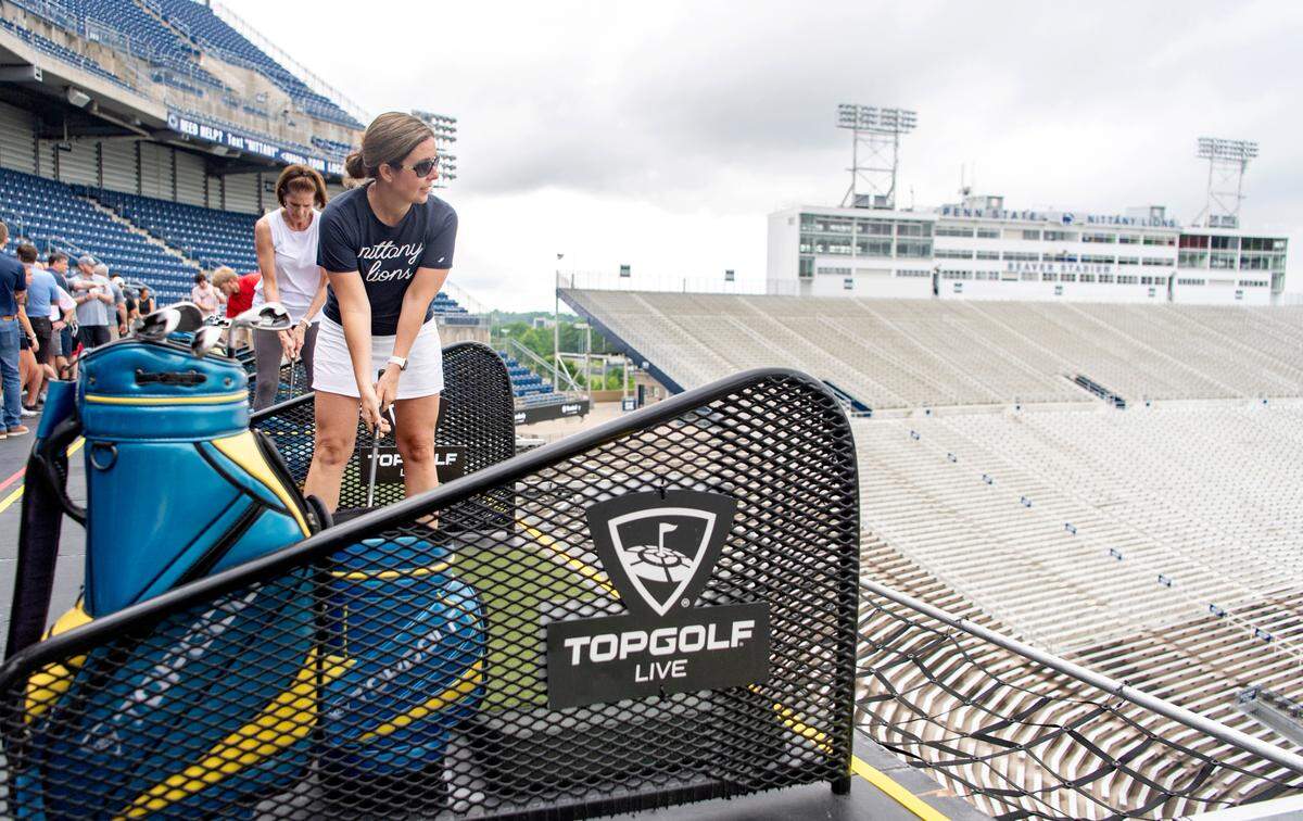 Tricia Kohler lines up her shot at Topgolf Live at Beaver Stadium on Thursday.