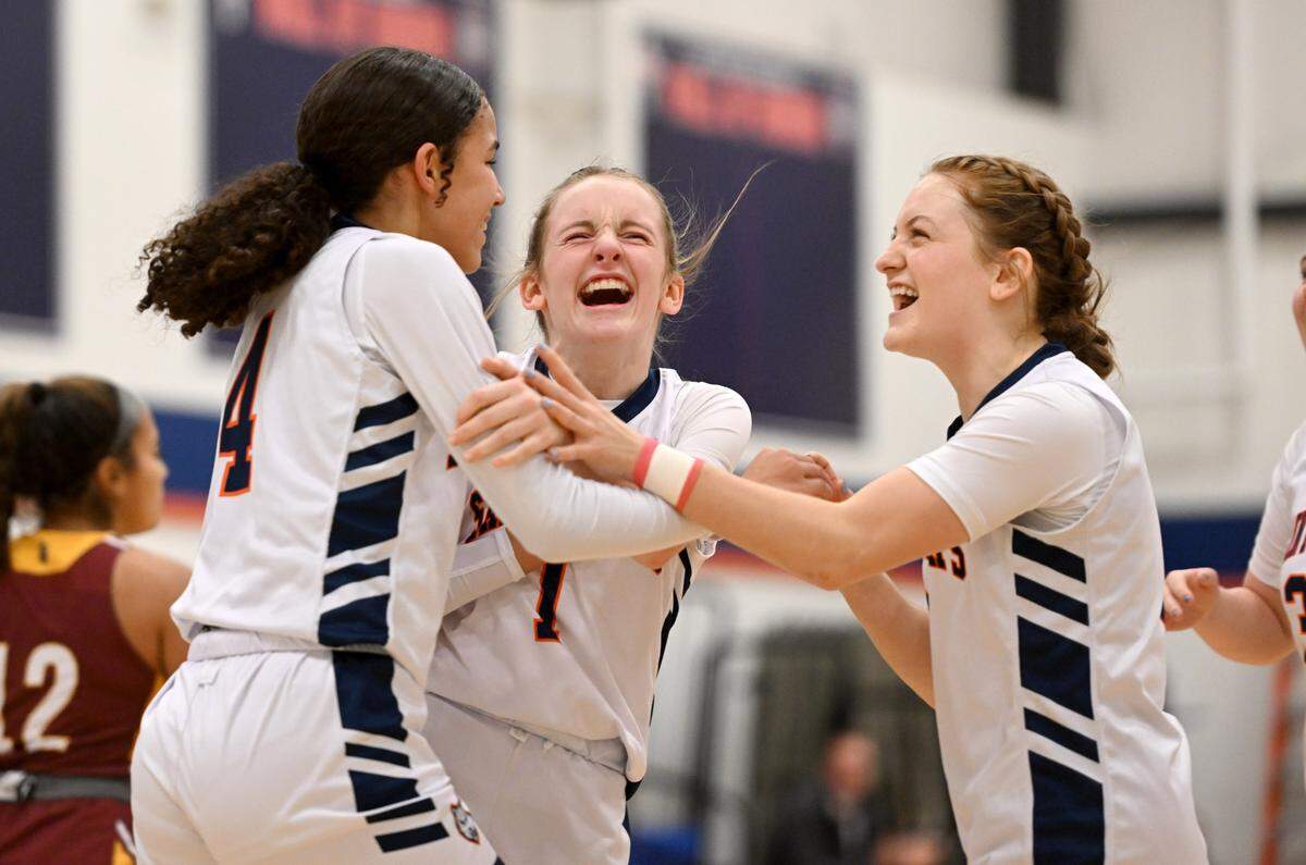 Saint Joseph’s Jacee Cunningham, Alexia Luckovich and Naomi Crispin celebrate a basket and a foul during the game against Millersburg on Wednesday, Jan. 17, 2024.
