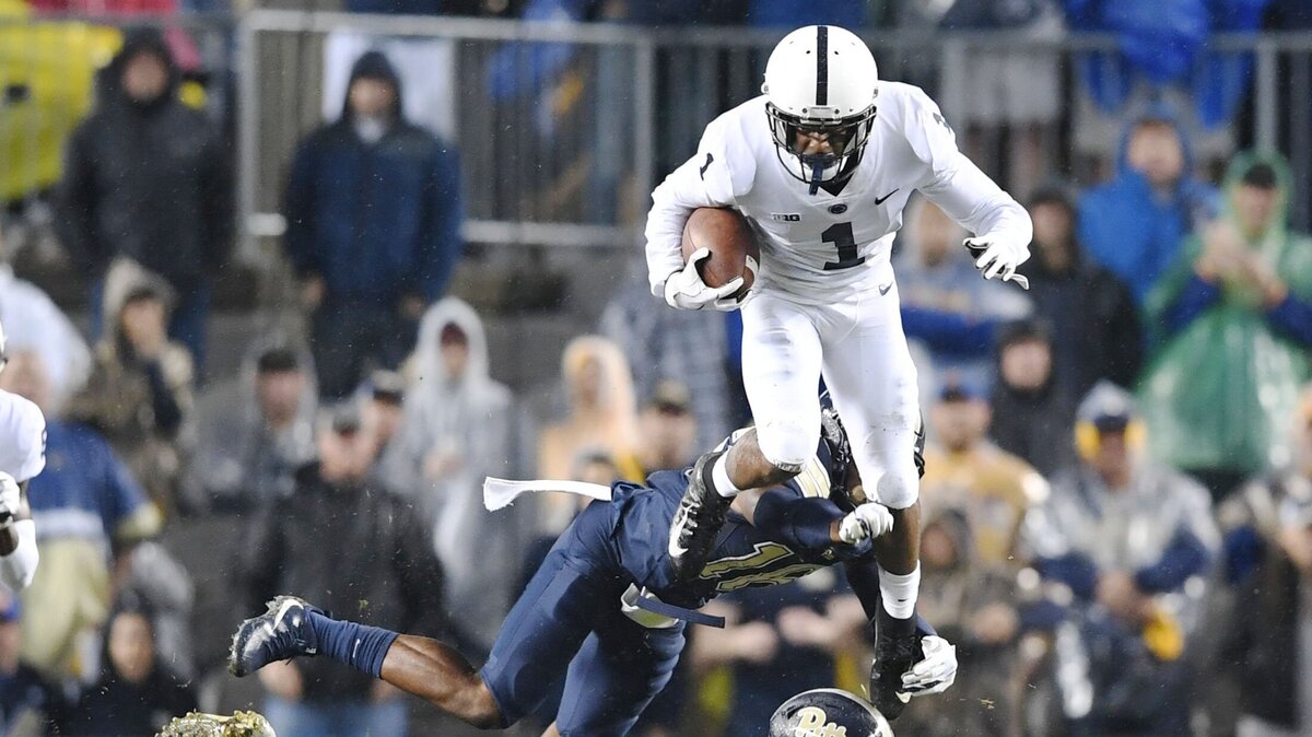 Penn State wide receiver KJ Hamler leaps over two defenders during a game against Pitt Saturday, Sept. 8, 2018 at Heinz Field.