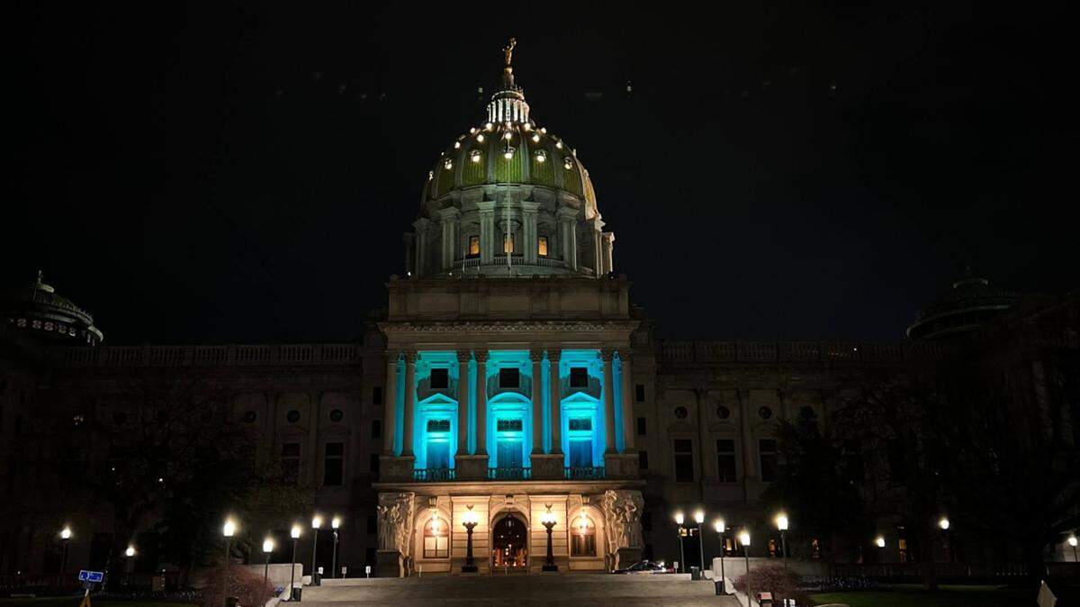 The Pennsylvania Capitol building illuminated in teal for Sexual Assault Awareness Month.