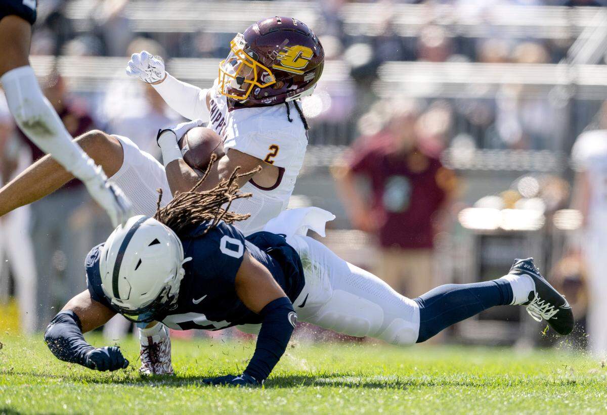 Penn State safety Jonathan Sutherland trips up Central Michigan’s Carlos Carriere during the game on Saturday, Sept. 24, 2022.