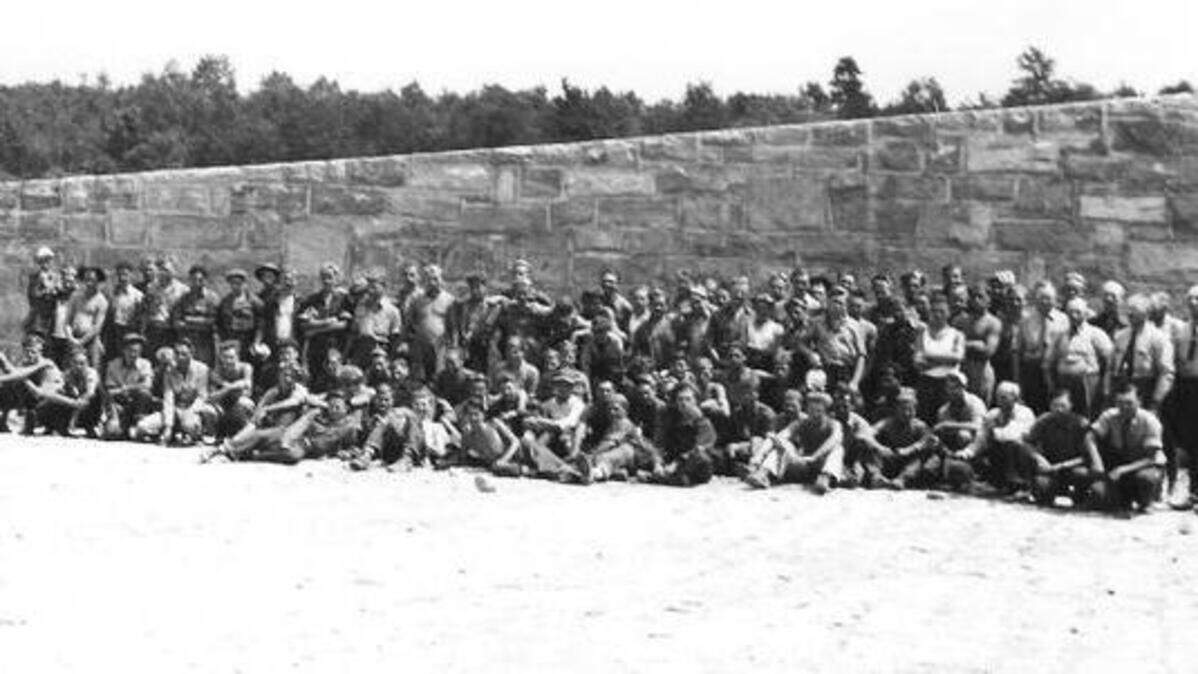 Civilian Conservation Corps enrollees pose near the spillway wall at what is now Poe Valley State Park.
