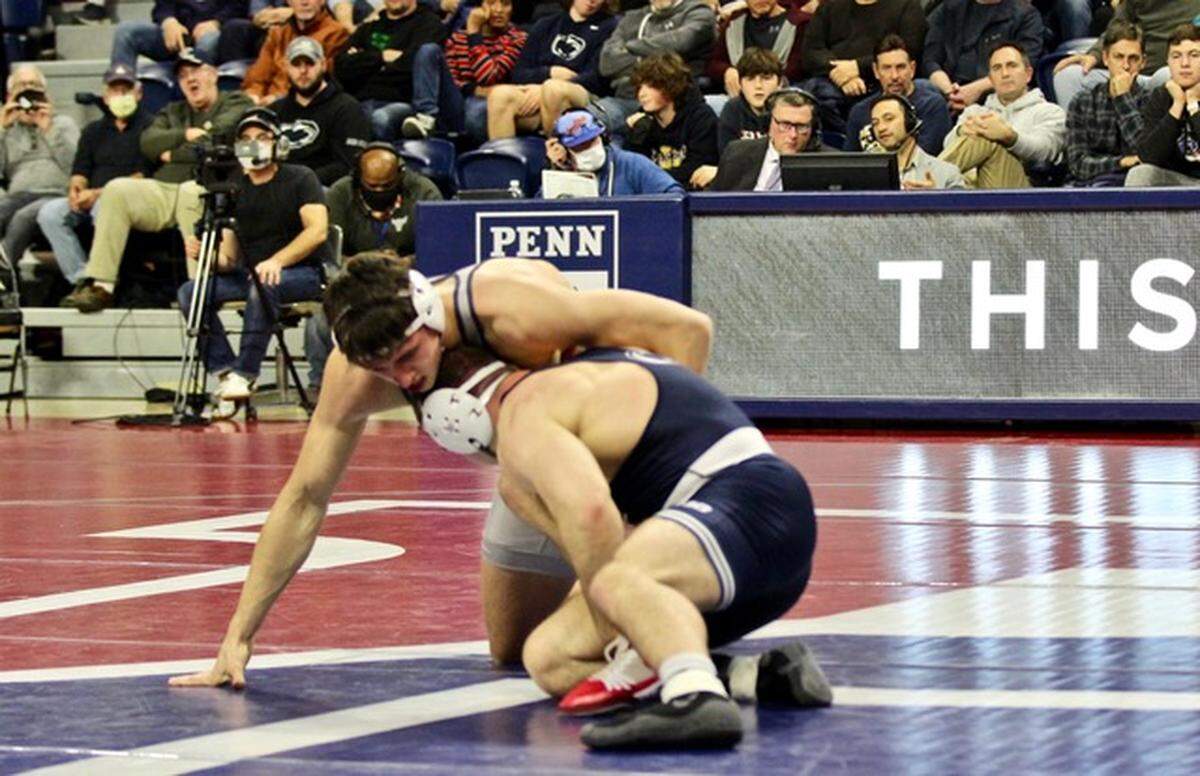 Penn wrestler and State College graduate Cole Urbas fights off a shot attempt from Penn State’s Max Dean in their 197-pound bout during the Nittany Lions’ and Quakers’ Dec. 3 dual.