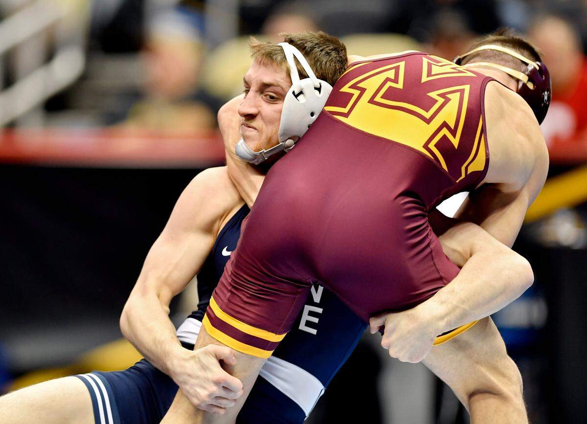 Penn State’s Nick Lee takes down Minnesota’s Mitch McKee in the 141 lb fifth place bout at the NCAA Division 1 Wrestling championships on Saturday, March 23, 2019 at PPG Paints Arena. Lee won by fall at 3:22.