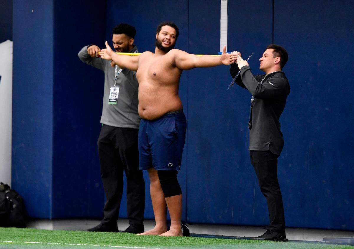 Penn State defensive tackle PJ Mustipher gets measurements taken during Penn State pro day on Thursday, March 24, 2022. Mustipher will play for the Nittany Lions this season as he continues to recover from an injury and will look to enter the draft in 2023.