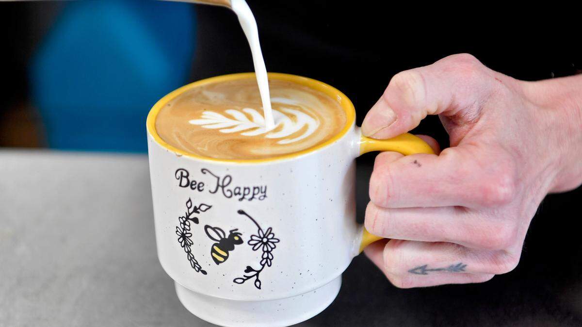 Bromlyn Fitzgerald of Bees Knees Coffee makes a design in a latte on Wednesday, Feb. 2, 2022.
