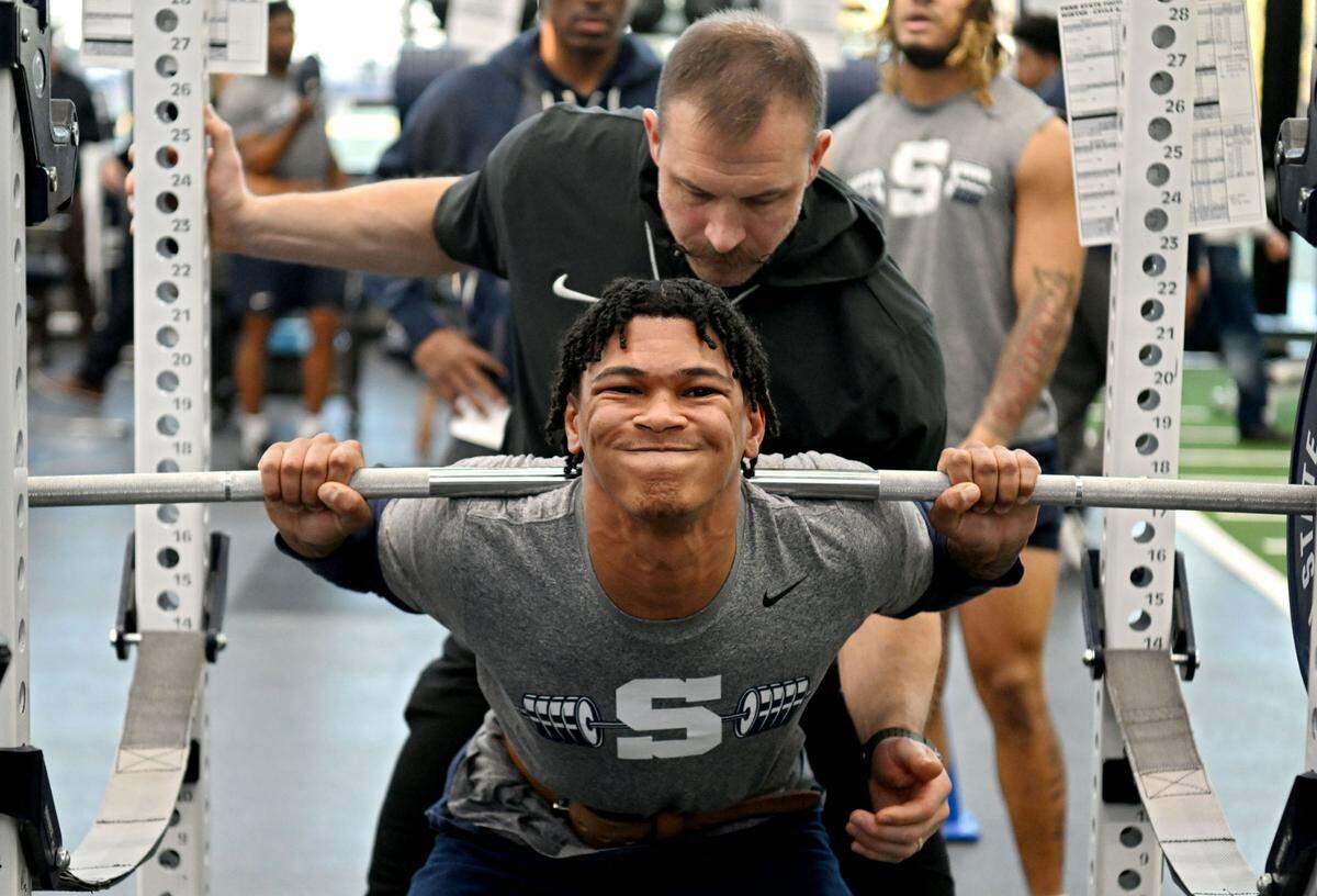 Penn State strength and conditioning coach Chuck Losey spots for safety Zakee Wheatley as he lifts during a winter workout session on Thursday, Feb. 29, 2024.