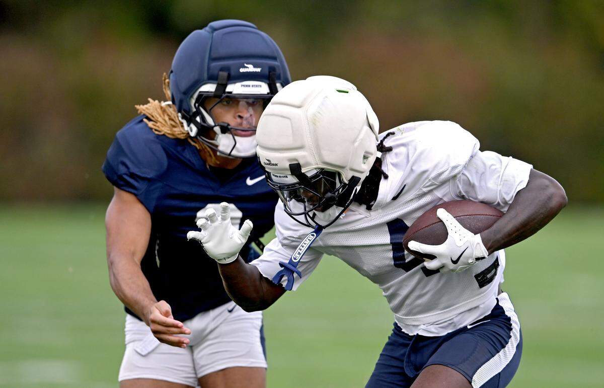 Penn State wide receiver Tyseer Denmark makes a catch and tries to cut around safety Antoine Belgrave-Shorter during practice on Tuesday, Sept. 16, 2025.  