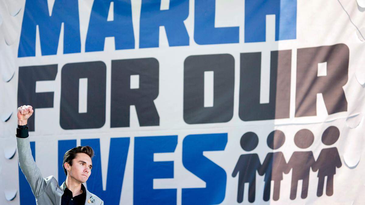 David Hogg, a survivor of the mass shooting at Marjory Stoneman Douglas High School in Parkland, Fla., raises his fist after speaking during the “March for Our Lives” rally in support of gun control in Washington, Saturday, March 24, 2018. (AP Photo/Andrew Harnik)