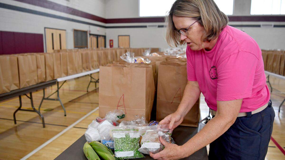 State College Area School District’s food service director Megan Schaper shows items included in bag for the food distribution on June 30. Schaper was named the School Nutrition Association’s Director of the Year for Pennsylvania.